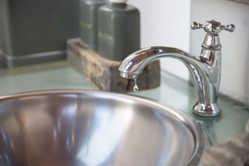 Water dripping from faucet Water dripping from faucet