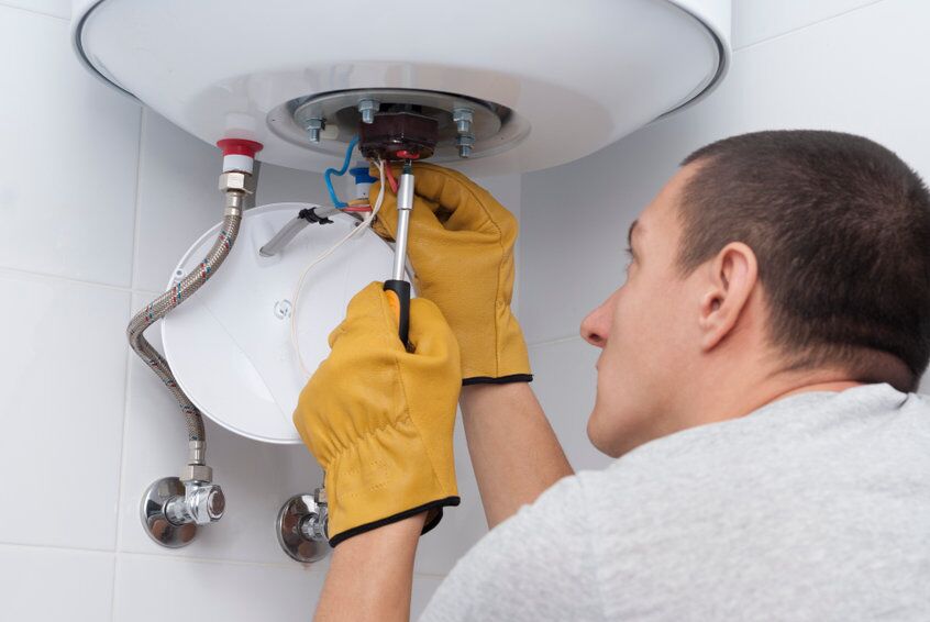repair electric boiler repairman for an electric boiler connects the wires to a thermostat