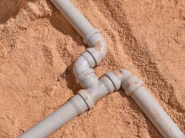 Junction of plastic sewer pipes. Sewage pipeline system of residential building under construction Junction of plastic sewer pipes. Sewage pipeline system of residential building under construction.
