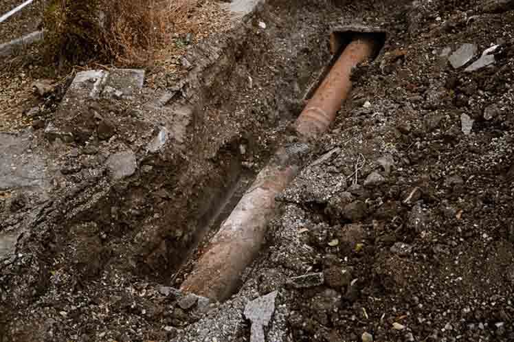Old Rusty Pipe for water in a trench open for repair top view Old Rusty Pipe for water in a trench open for repair top view.