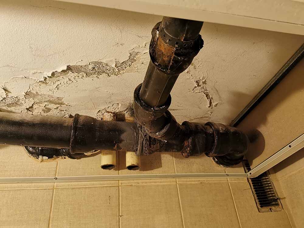 A damaged sewer pipe with water leaking out A damaged sewer pipe with water leaking out