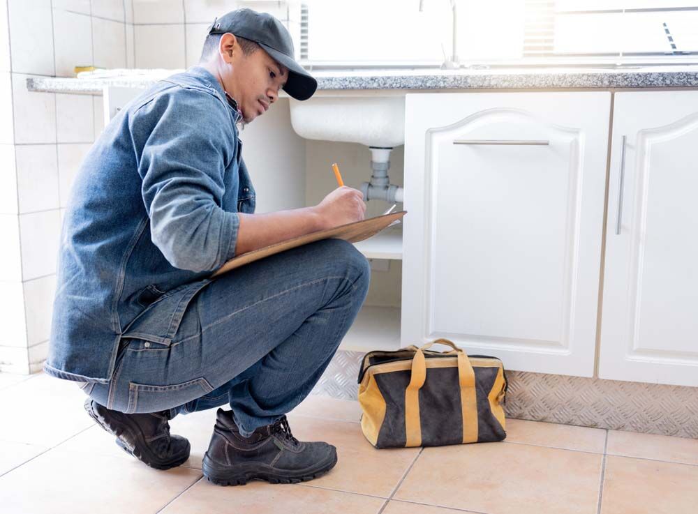 Plumber inspecting plumbing system Plumber inspecting plumbing system